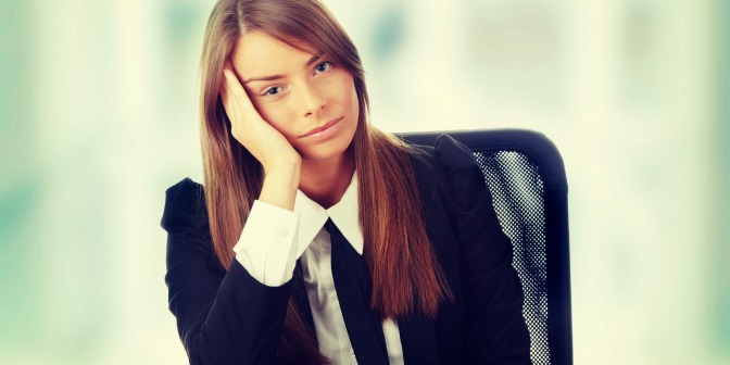 Frustrated event planner sitting at her desk