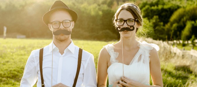 cute bride and groom wearing fake mustaches