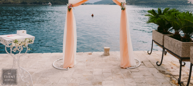 destination wedding with pink archway and ocean