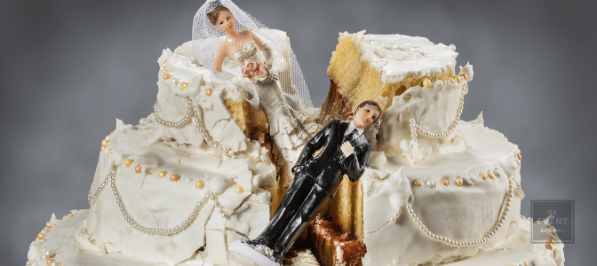 ruined wedding cake with bride and groom toppers stuck in the middle