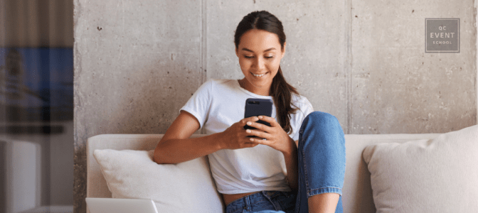 woman sitting on couch reading QC Pet Studies blog on phone